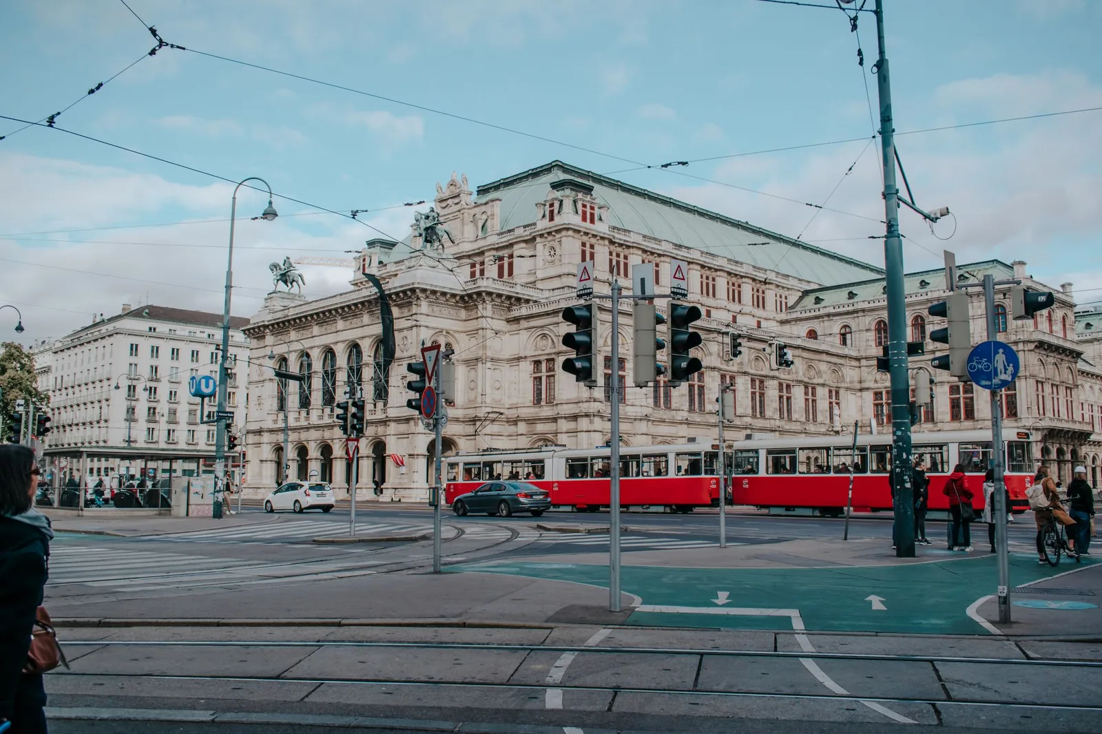 Red Vienna tram passing the State Opera house on the Ringstrasse