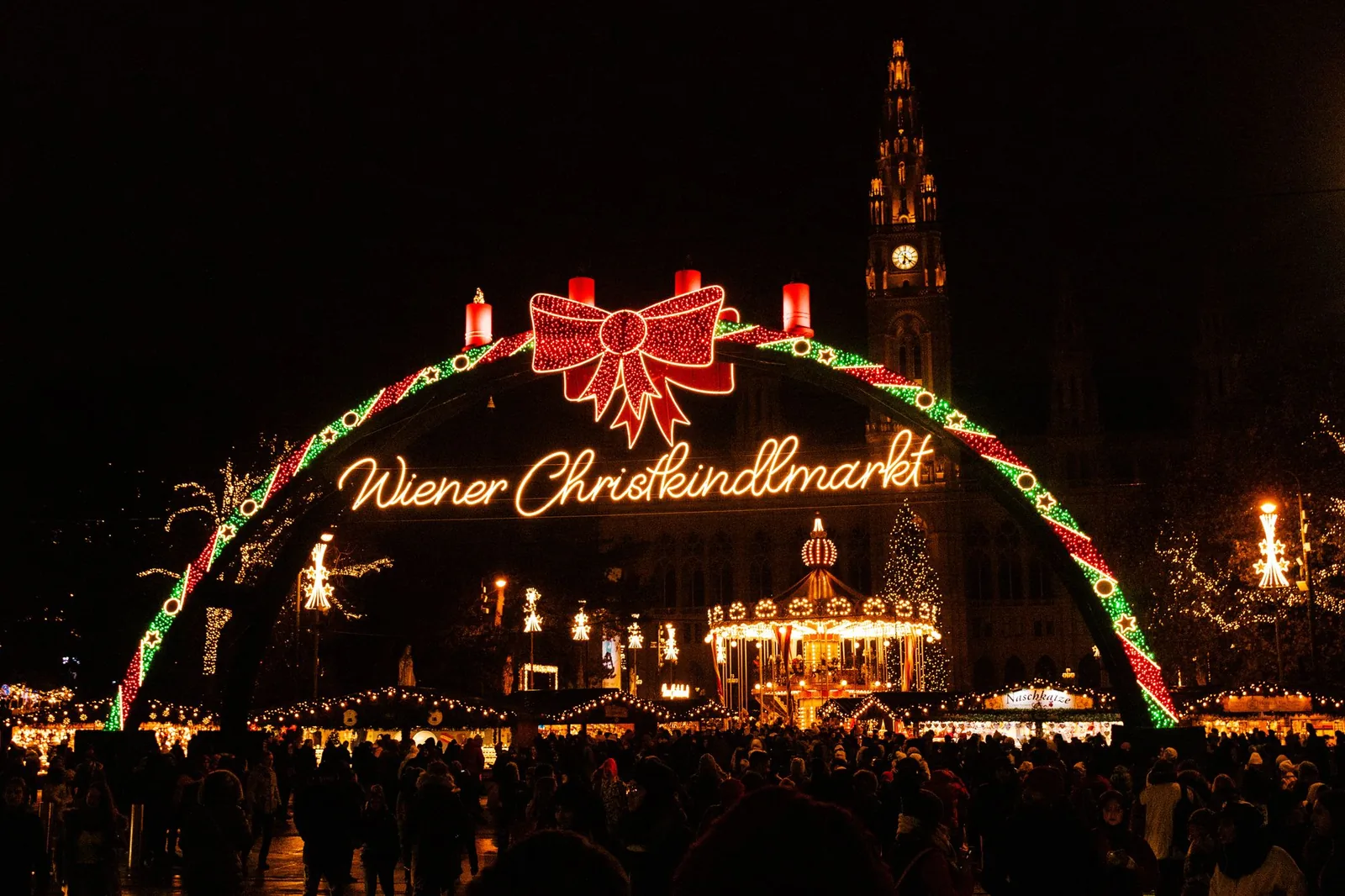 Illuminated entrance arch of a Vienna Christmas market on a winter evening
