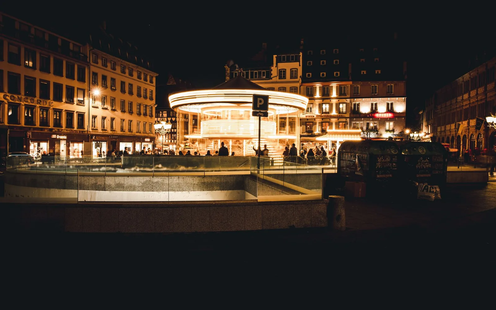Vintage carousel lit up at night on a square in Strasbourg, France