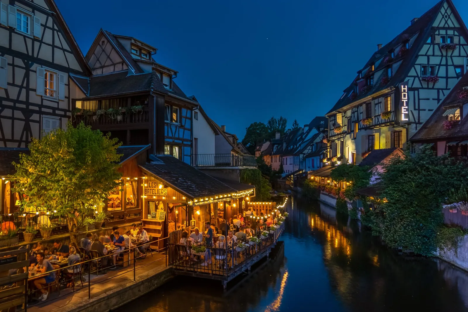 Half-timbered houses and canal-side lights in Colmar at night