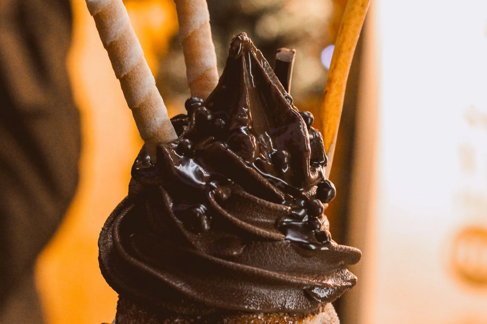 Chocolate-topped trdelník chimney cake held up on a Prague street